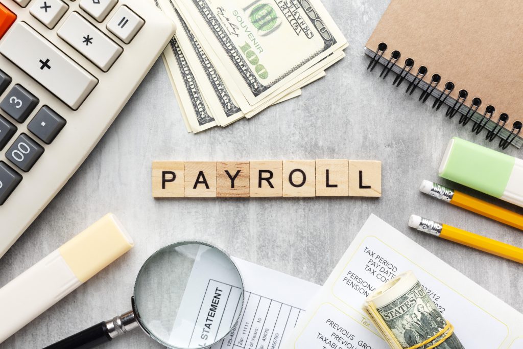 top view payroll concept with items scaled